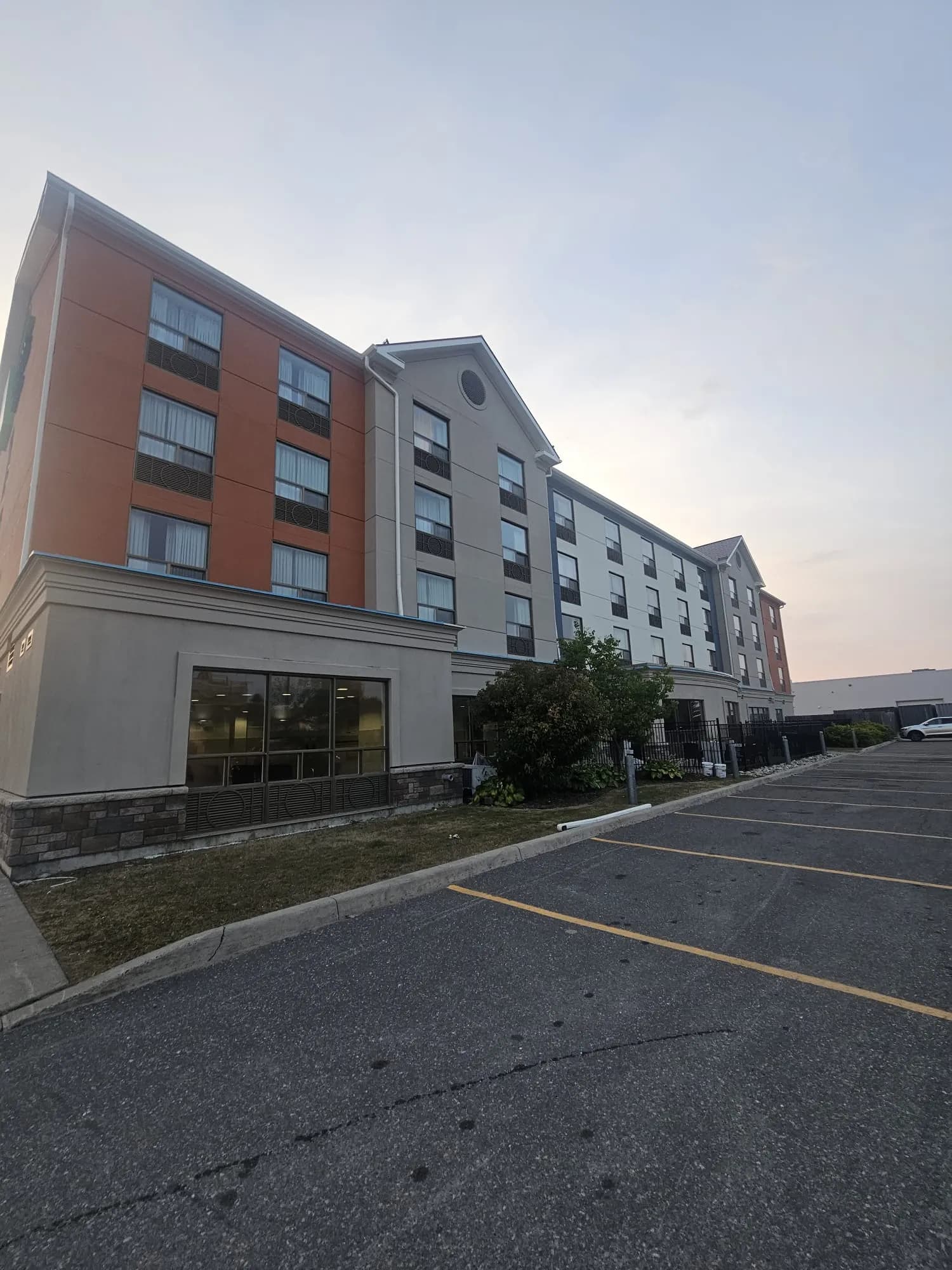 Holiday Inn Express, New Liskeard — End block in terracotta beside the taupe gable bay