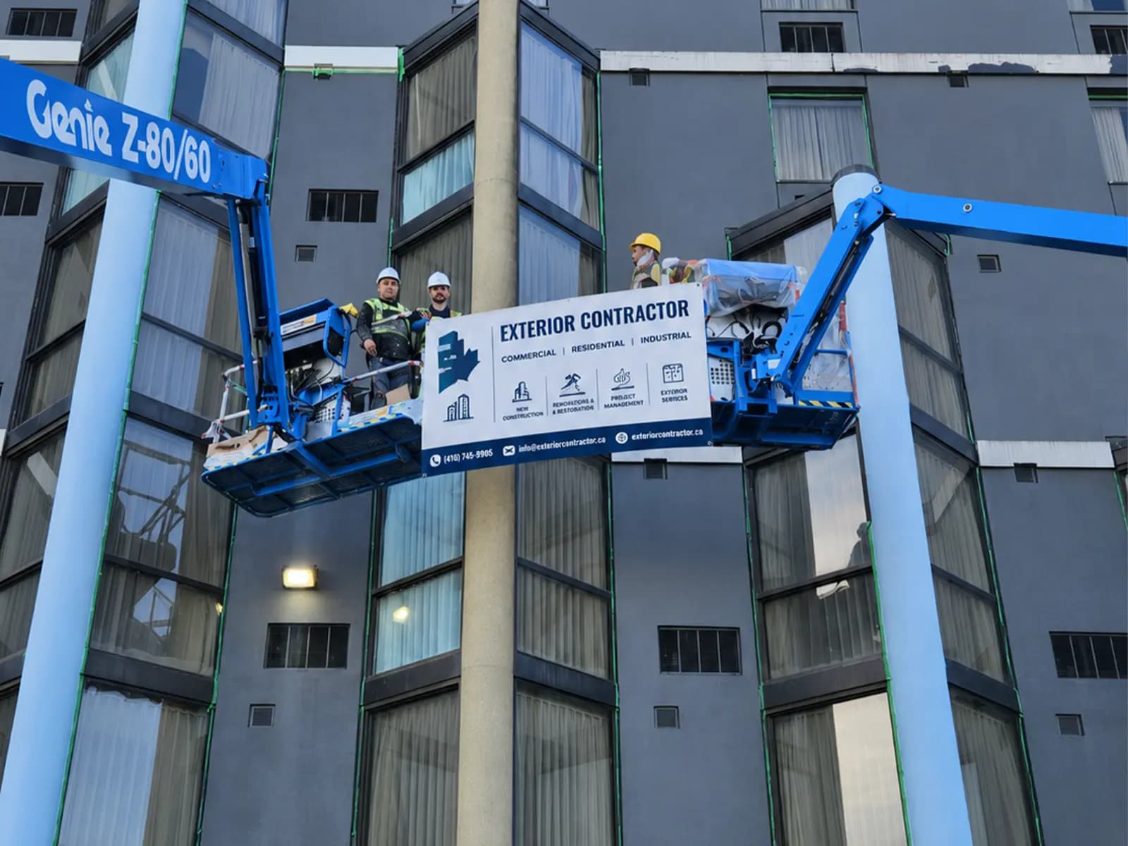 Maple Build crew working from boom lifts on a commercial building envelope